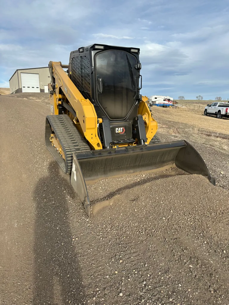 No Limit Solutions skid steer working pen and lot grading on an active Northern Colorado cattle operation, livestock visible alongside.